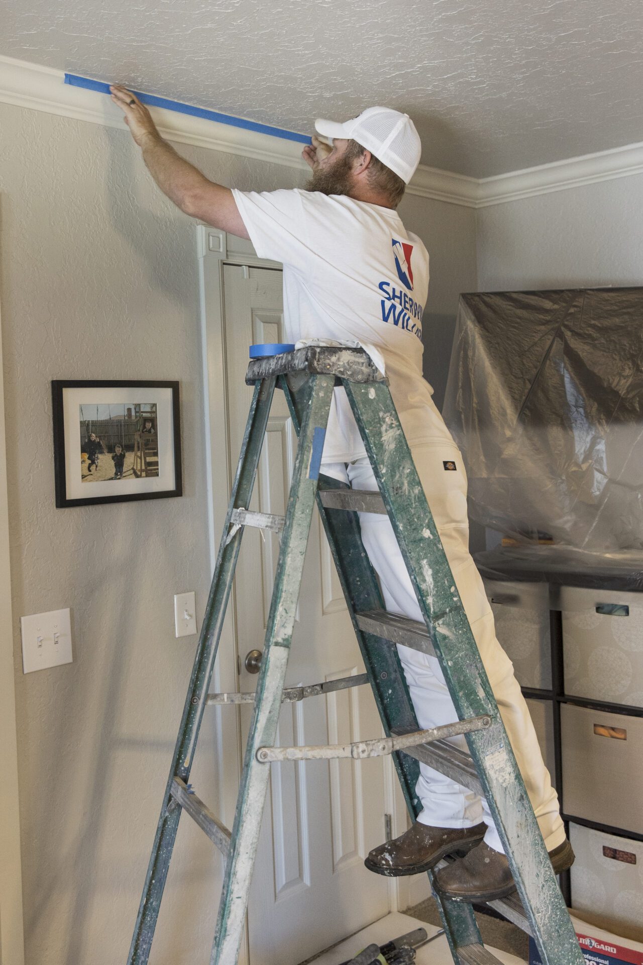 A man measuring wall length