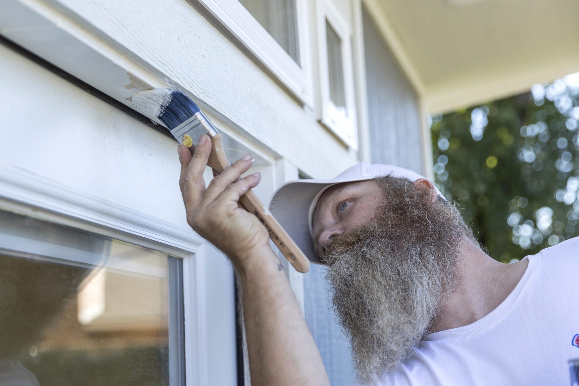 A man painting the window